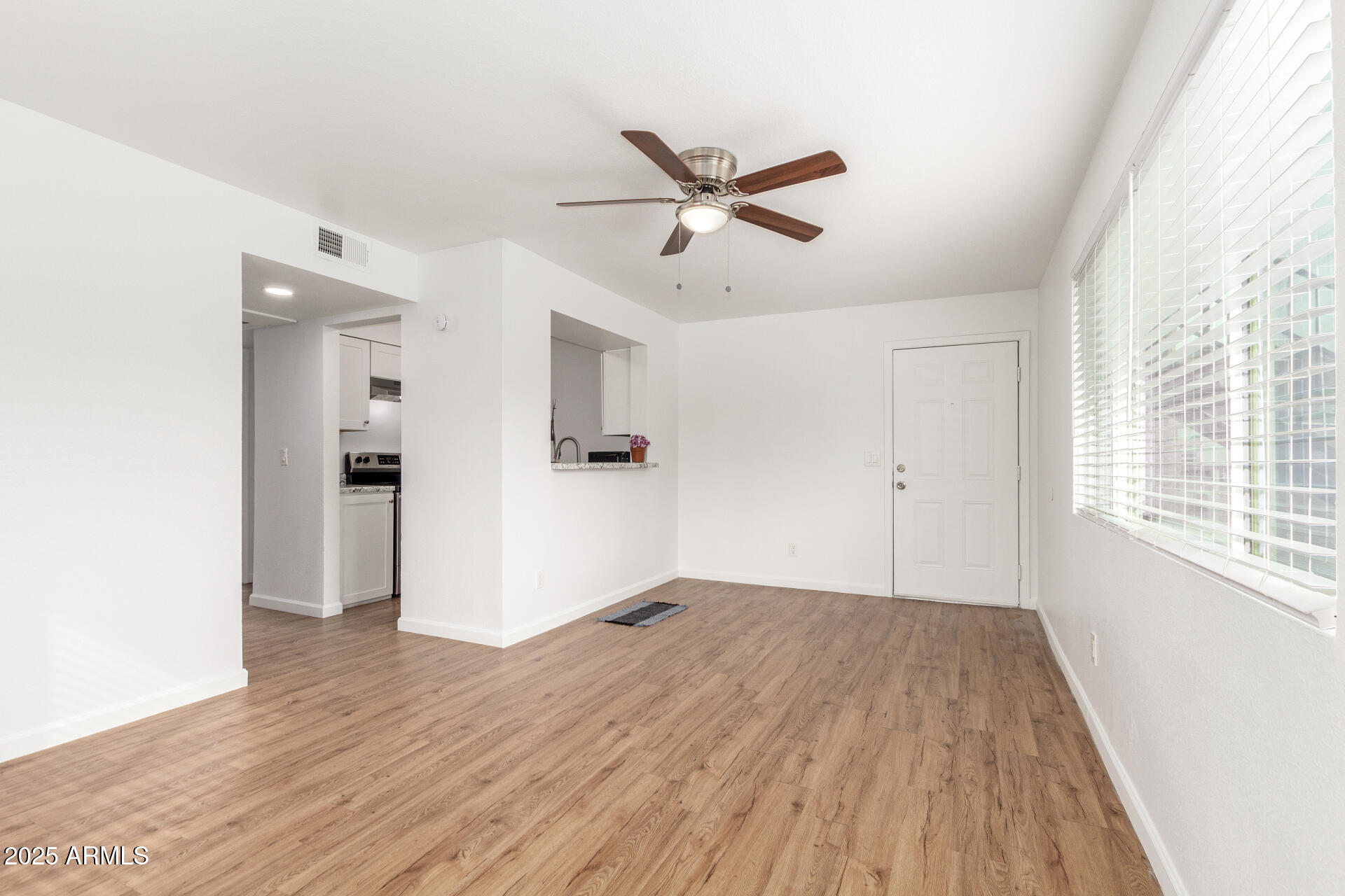 1346 East Mountain View Road, Unit 207 Phoenix, AZ 85020 - Photo 12 of 29 a view of empty room with wooden floor and fan