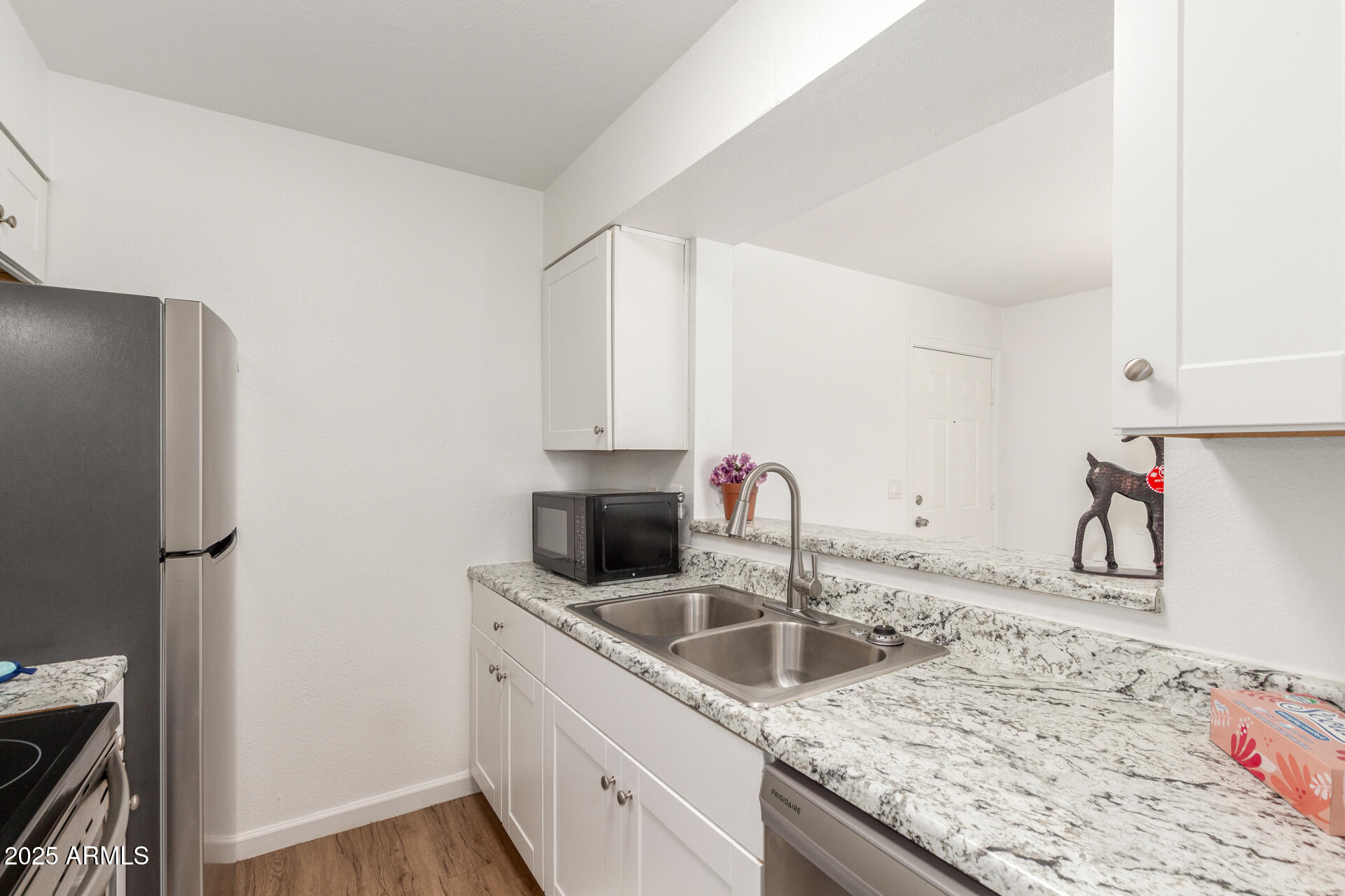 1346 East Mountain View Road, Unit 207 Phoenix, AZ 85020 - Photo 17 of 29 a kitchen with stainless steel appliances granite countertop a sink stove and refrigerator