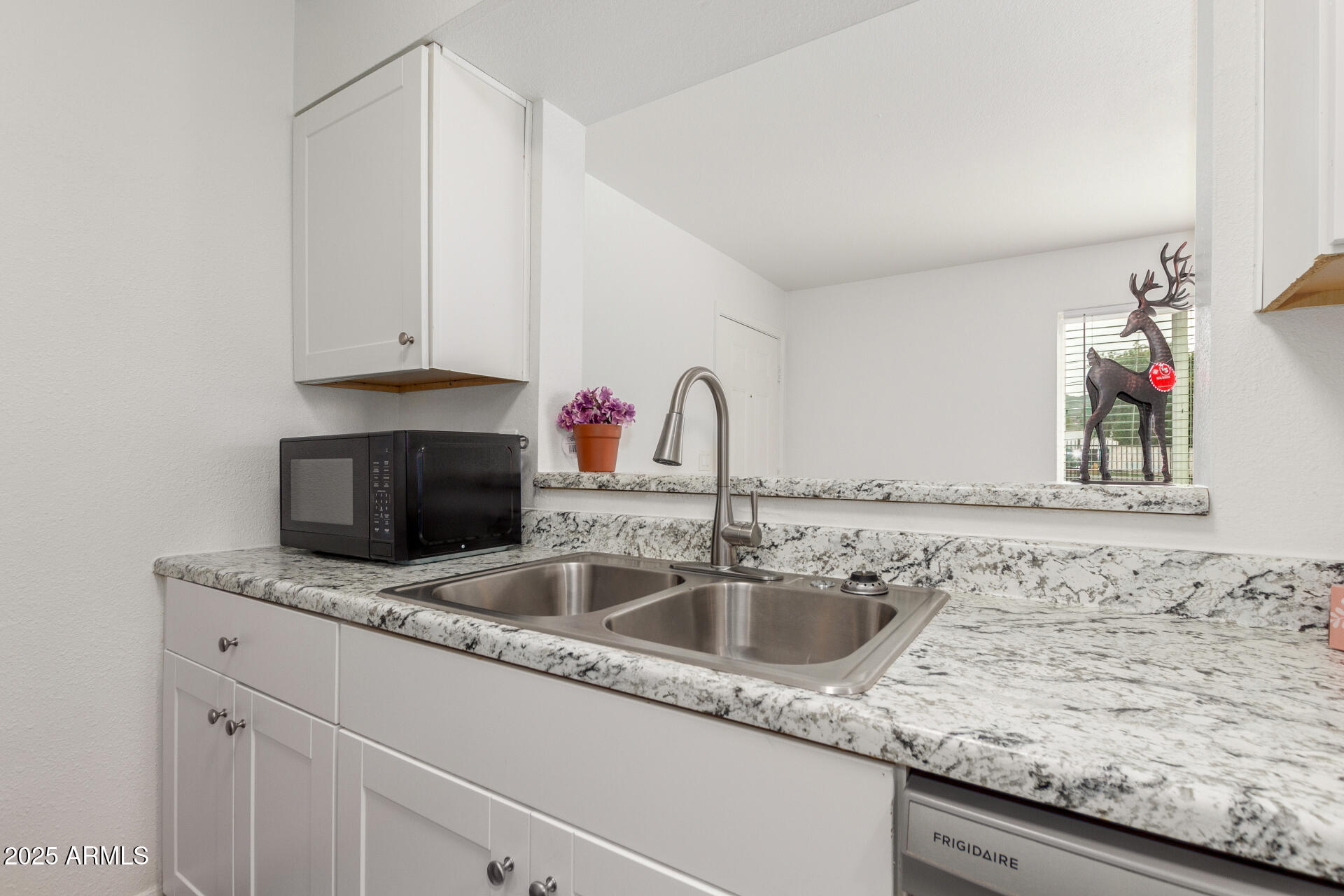 1346 East Mountain View Road, Unit 207 Phoenix, AZ 85020 - Photo 19 of 29 a kitchen with granite countertop a sink and a stove