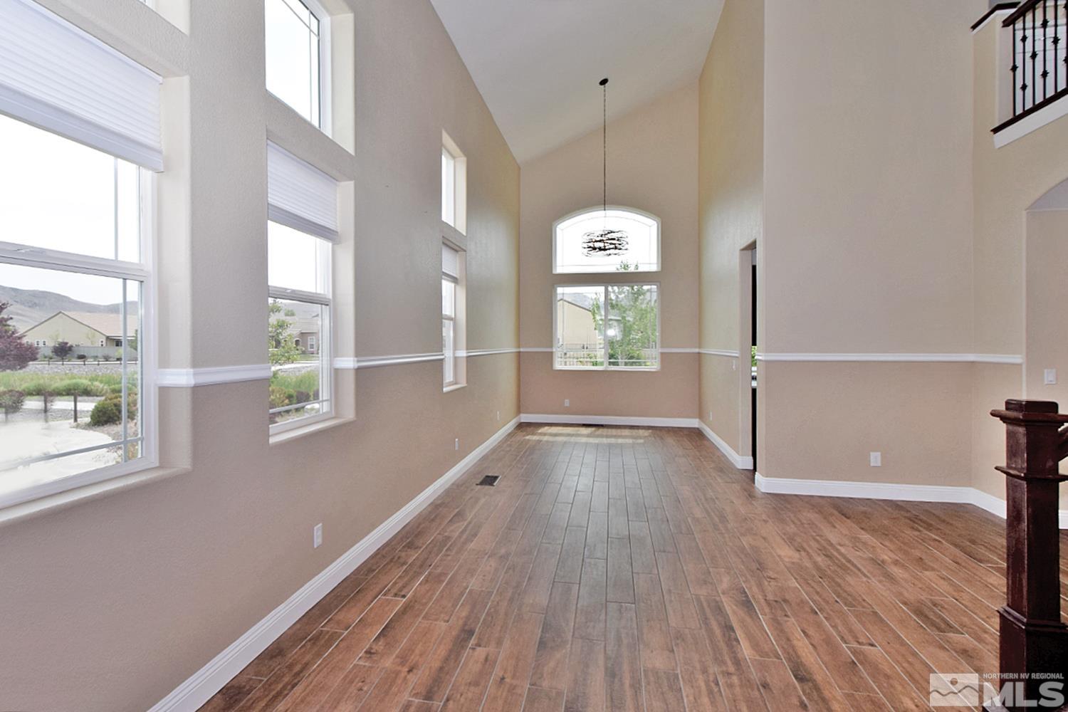 1670 Ashworth Court Reno, NV 89521 - Photo 4 of 33 a view of empty room with wooden floor and fan
