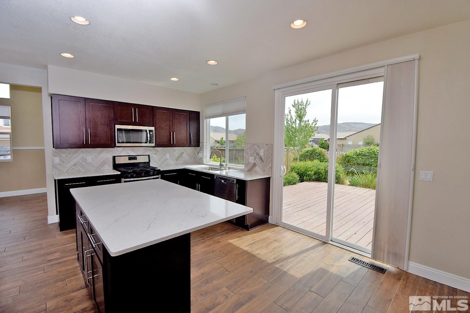 1670 Ashworth Court Reno, NV 89521 - Photo 8 of 33 a kitchen with a sink a counter top space cabinets and stainless steel appliances