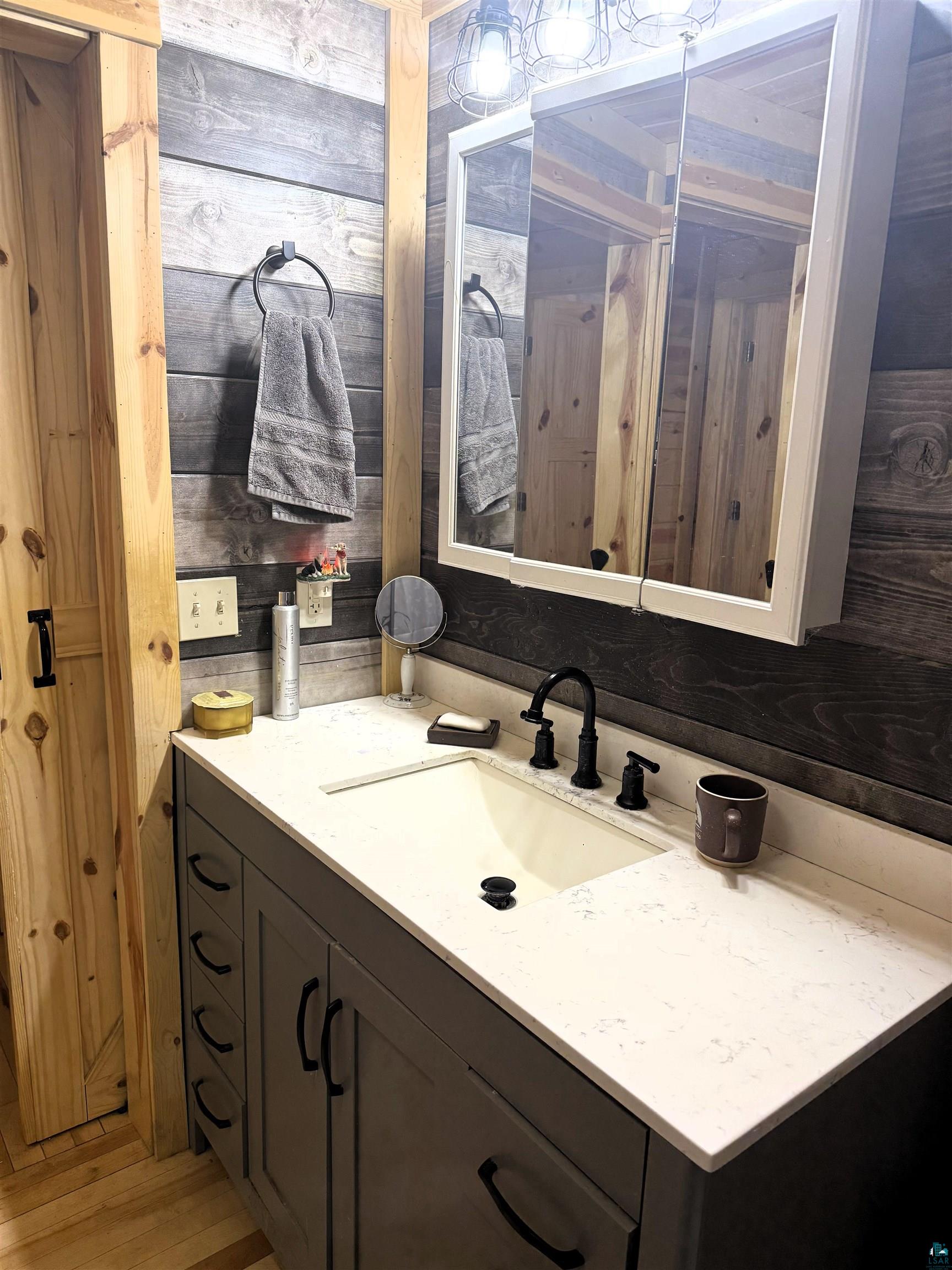 37590 Degerstrom Road Askov, MN 55704 - Photo 20 of 53 Bathroom vanity featuring a quartz countertop, integrated sink, and matte black faucet