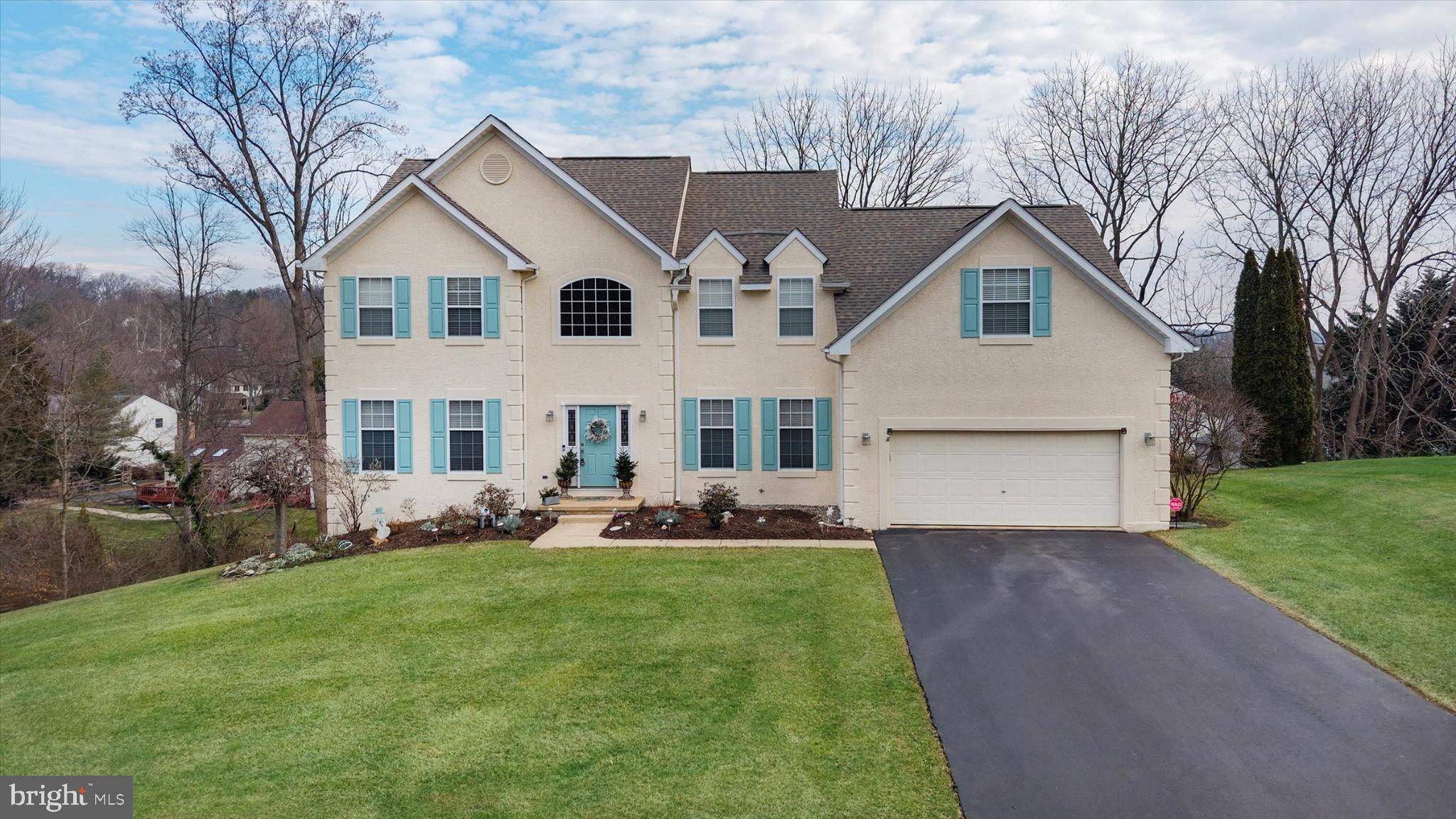 7 Pierson's Ridge Hockessin, DE 19707 - Photo 2 of 52 a front view of a house with a garden and yard