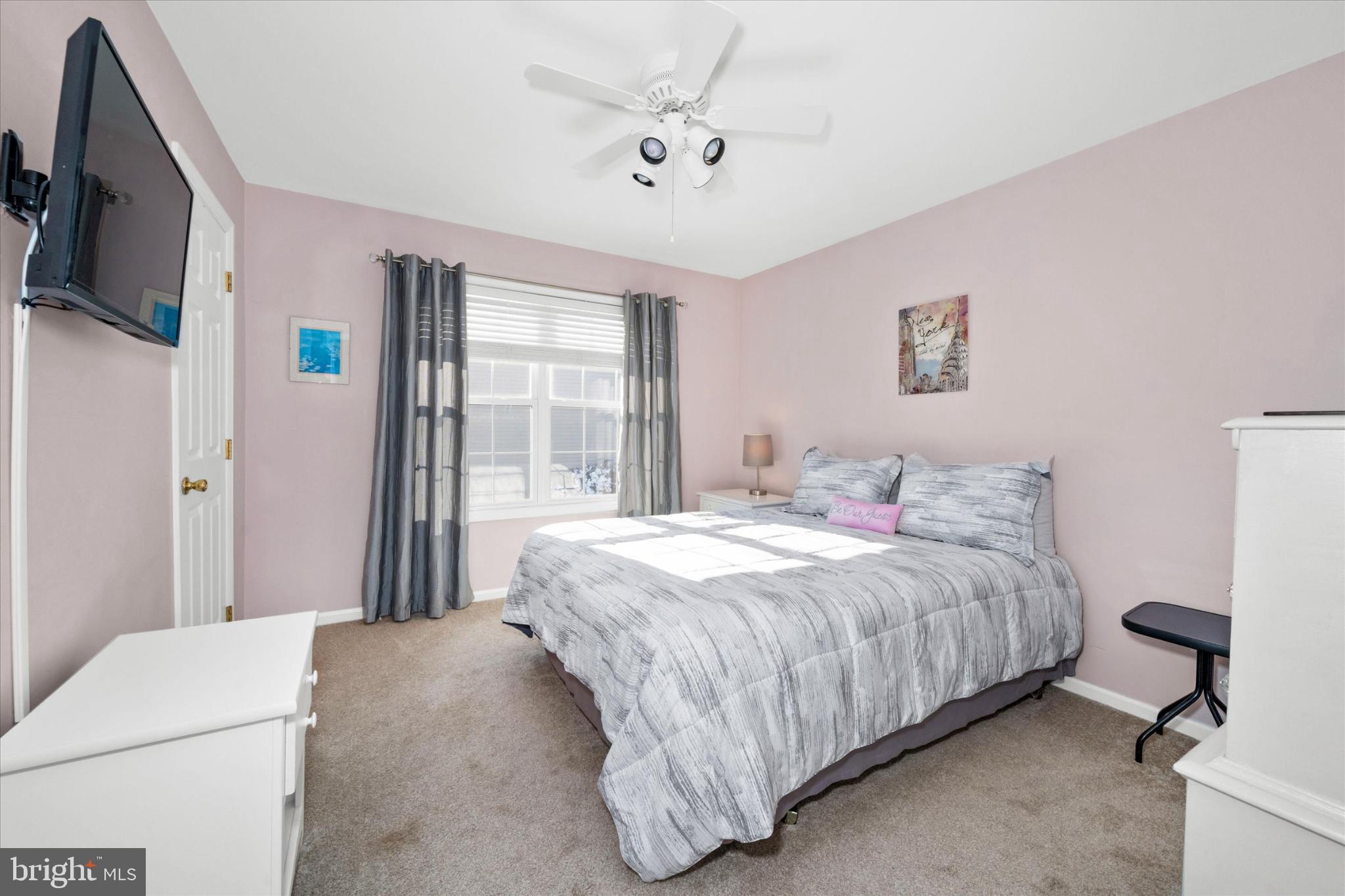 7 Pierson's Ridge Hockessin, DE 19707 - Photo 35 of 52 a bedroom with a bed flat screen tv and a window