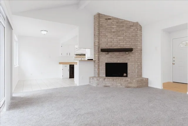 a view of empty room with a fireplace