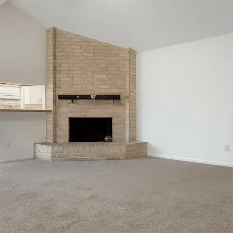 a view of an empty room with a fireplace