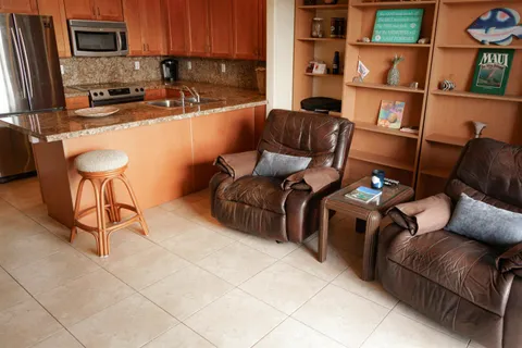 a kitchen with a table chairs and a refrigerator