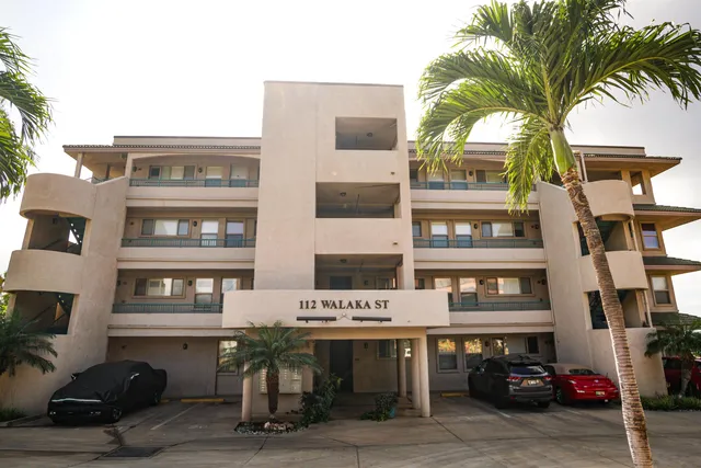 a kitchen with stainless steel appliances granite countertop a sink a microwave a refrigerator and counter space