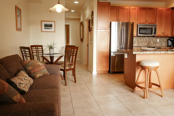 a kitchen with stainless steel appliances granite countertop a sink and dishwasher wooden cabinets with granite countertops