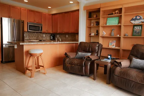 a kitchen with stainless steel appliances granite countertop a refrigerator and a stove top oven