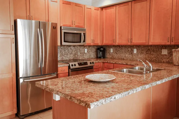 a kitchen with a table chairs and a refrigerator