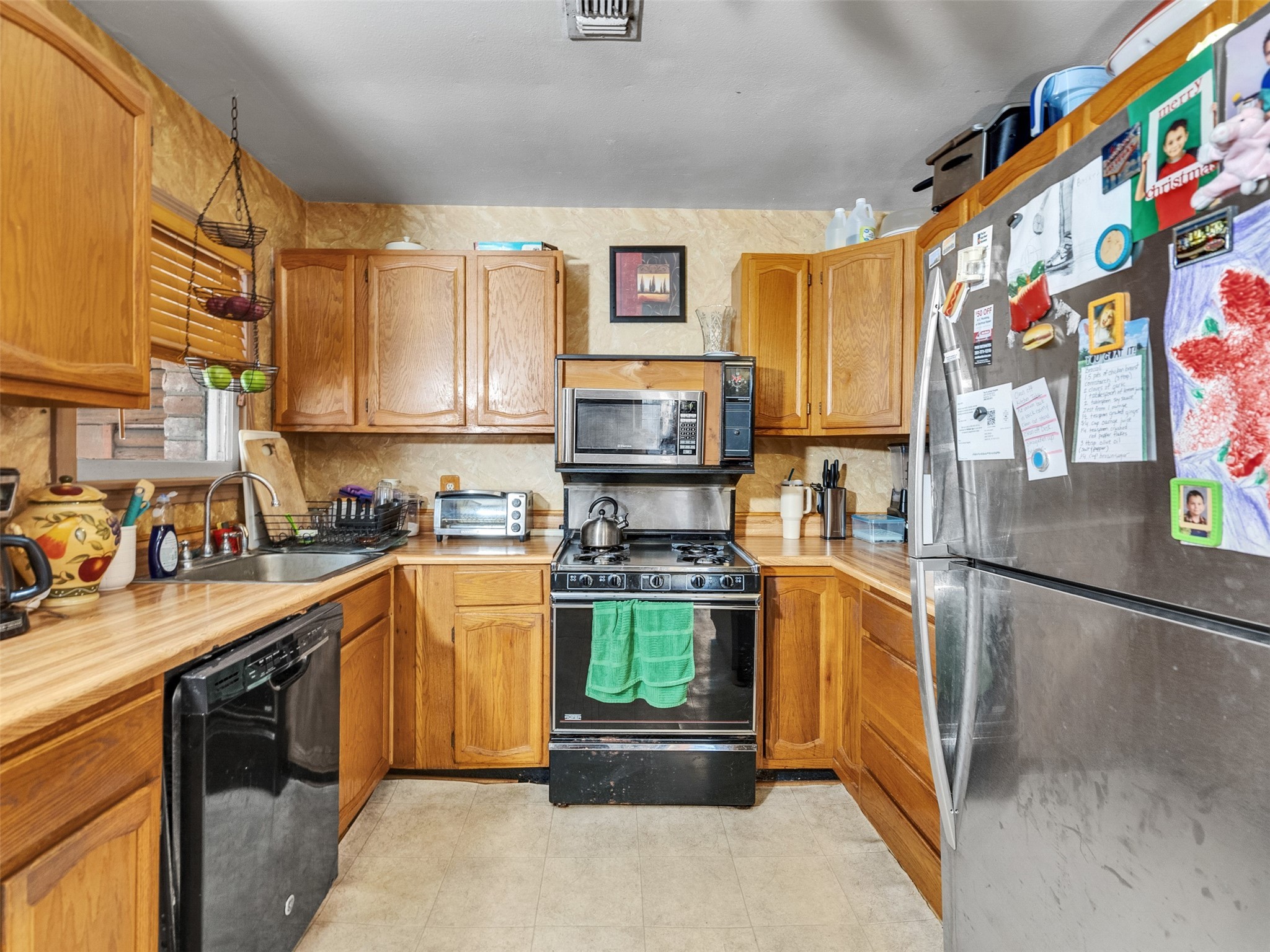 3908 Terry Street Santa Fe, TX 77517 - Photo 16 of 28 a kitchen with stainless steel appliances granite countertop a stove and a refrigerator