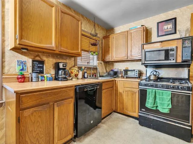 a kitchen with stainless steel appliances granite countertop a stove sink and cabinets