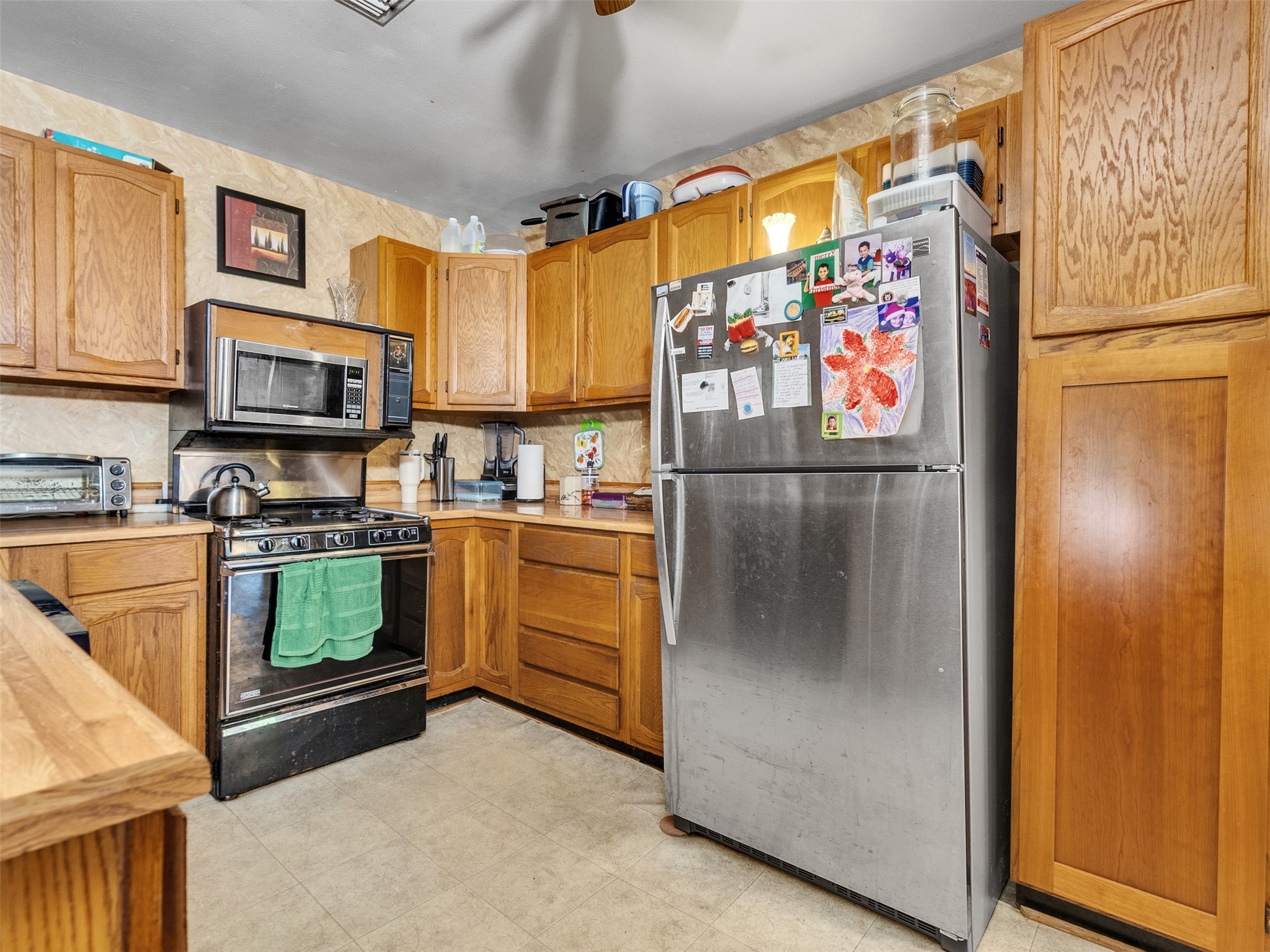 3908 Terry Street Santa Fe, TX 77517 - Photo 18 of 28 a kitchen with stainless steel appliances granite countertop a refrigerator a stove and a sink