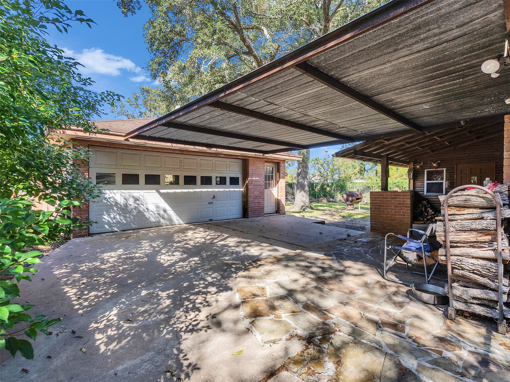3908 Terry Street Santa Fe, TX 77517 - Photo 24 of 28 a view of a patio with table and chairs under an umbrella with a barbeque