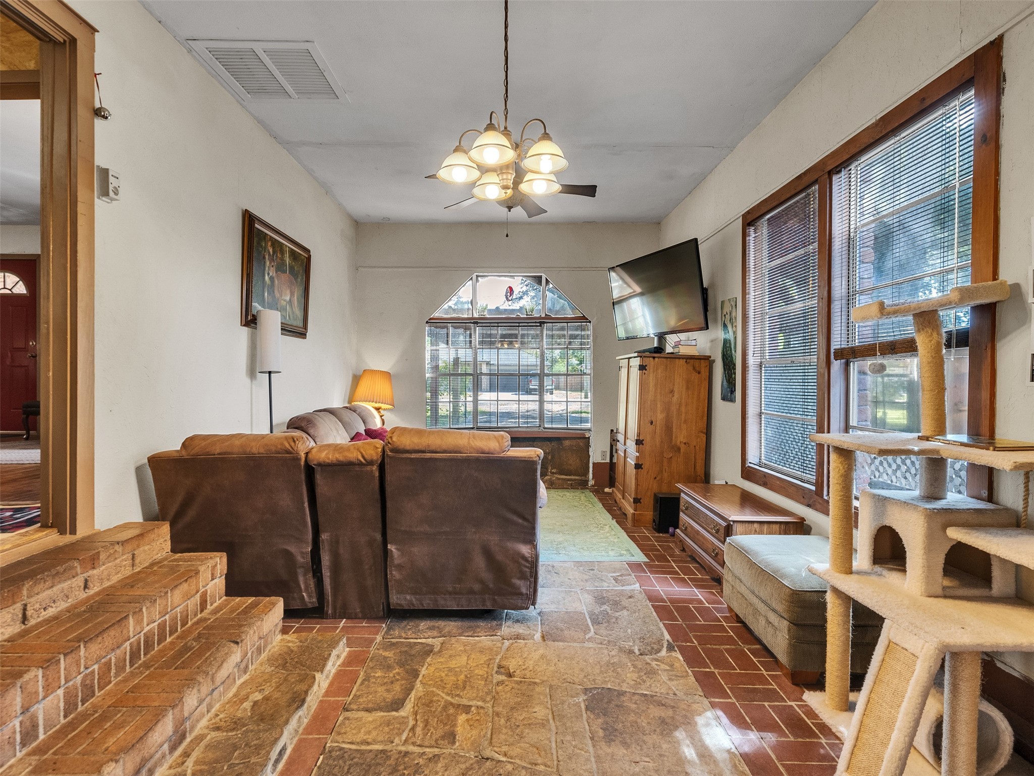 3908 Terry Street Santa Fe, TX 77517 - Photo 5 of 28 a living room with furniture a chandelier and a flat screen tv