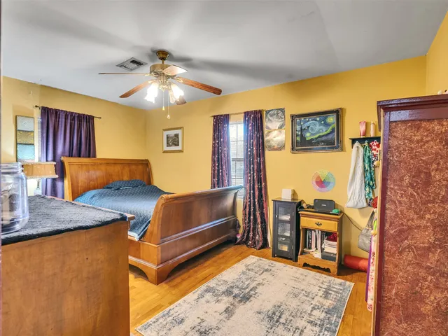 a living room with stainless steel appliances furniture a rug and a large window
