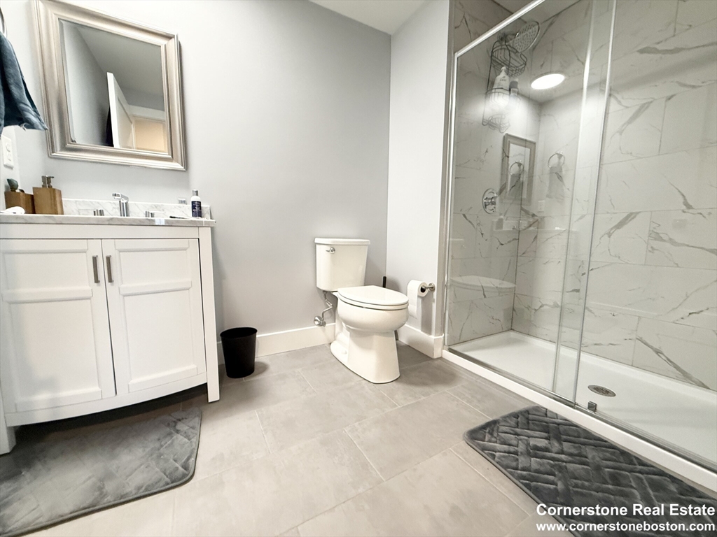 55 West Fifth Street, Unit 609 Boston, MA 02127 - Photo 5 of 7 a bathroom with a sink a toilet and shower