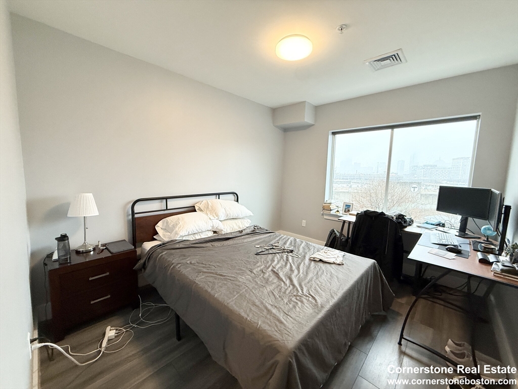 55 West Fifth Street, Unit 609 Boston, MA 02127 - Photo 6 of 7 a bedroom with a bed and a computer on the desk