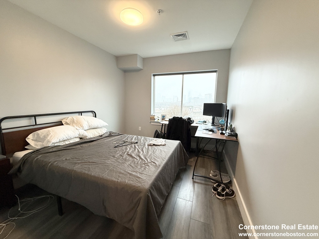 55 West Fifth Street, Unit 609 Boston, MA 02127 - Photo 7 of 7 a bedroom with a bed and a table