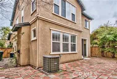 a view of a brick house with many windows