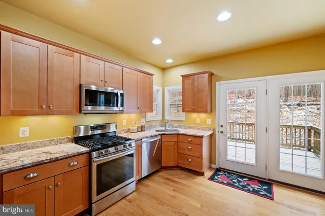a bedroom with a bed and a lamp on dresser