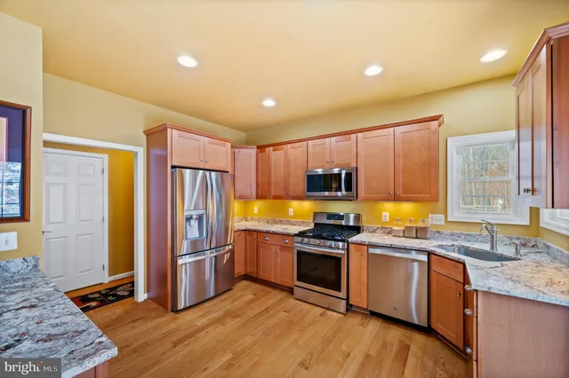 a bathroom with a granite countertop shower and a sink