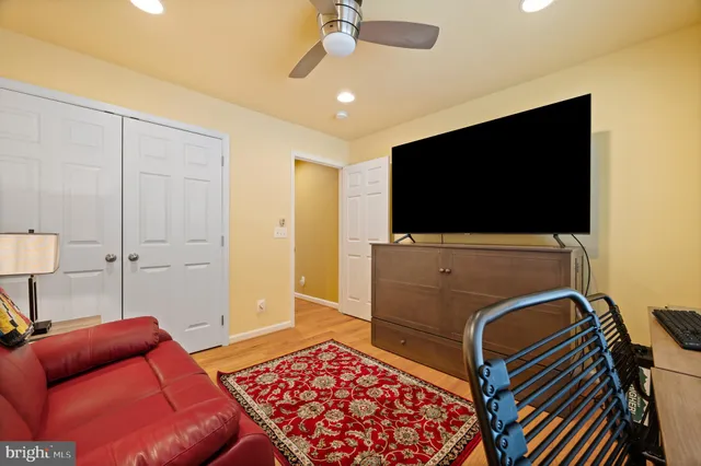 a view of a white house with a yard covered in snow