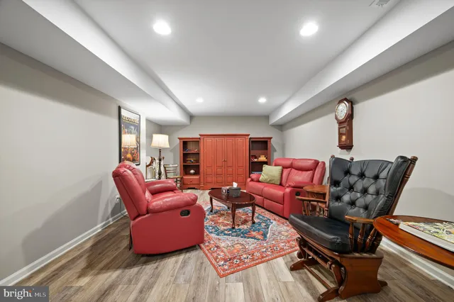 a view of a white house with a yard and wooden fence