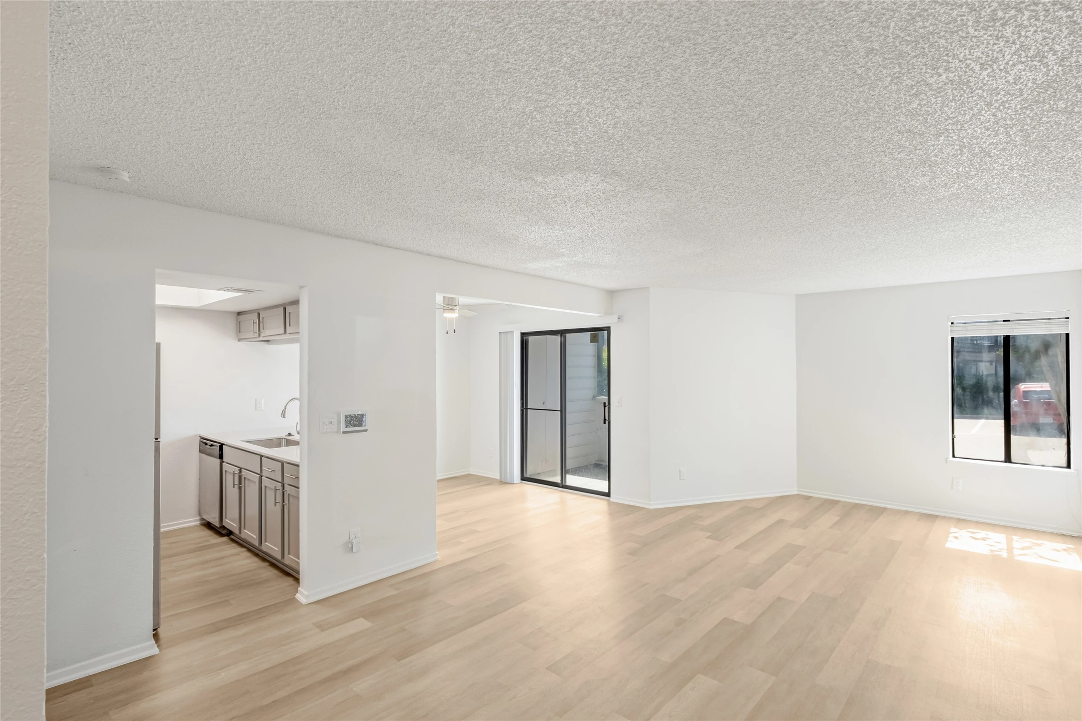 4600 West Pioneer Drive, Unit 302 Irving, TX 75061 - Photo 13 of 48 a view of an empty room with wooden floor and windows