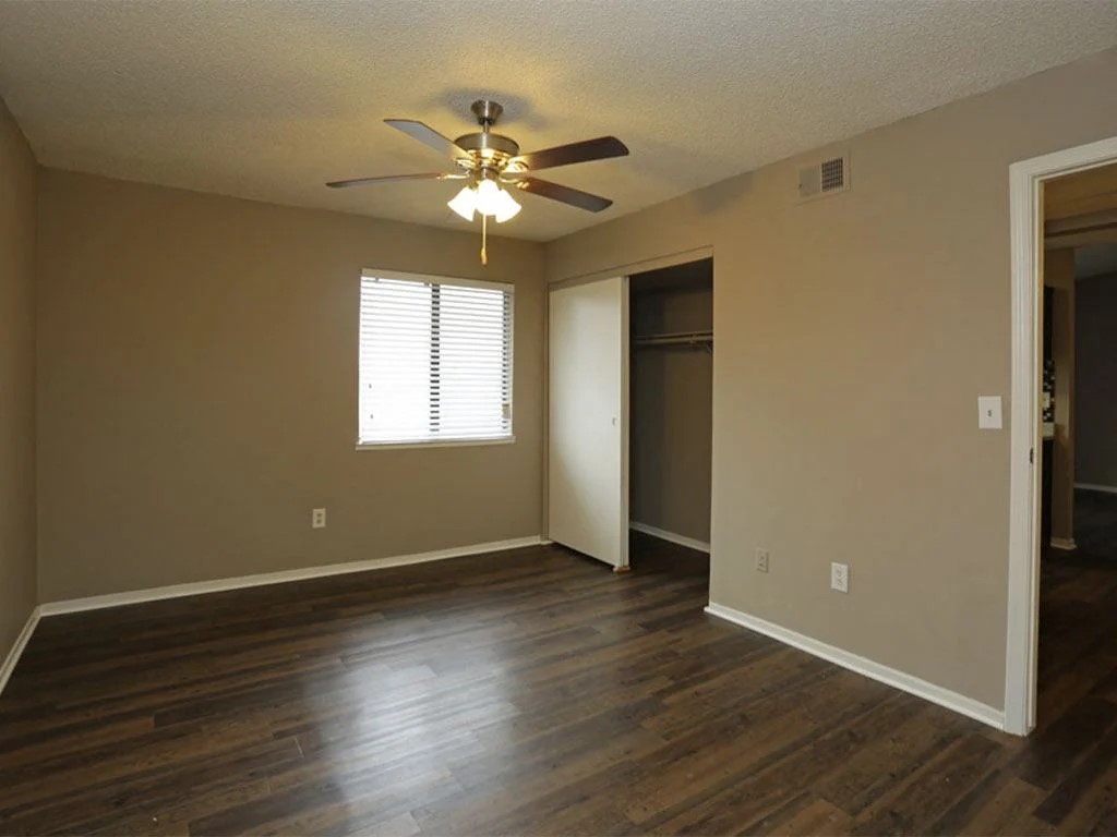 4600 West Pioneer Drive, Unit 302 Irving, TX 75061 - Photo 23 of 48 a view of an empty room with wooden floor and a window
