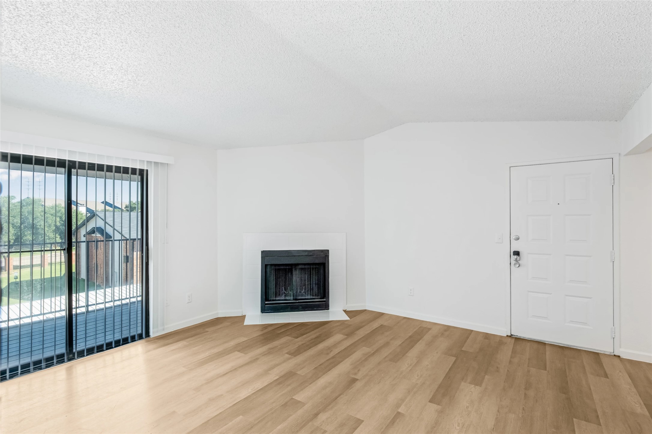 4600 West Pioneer Drive, Unit 302 Irving, TX 75061 - Photo 10 of 48 a view of an empty room with wooden floor and a window