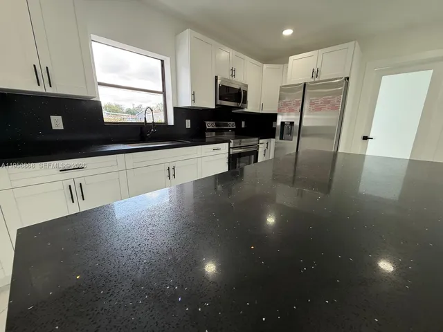 a kitchen with a stove and a microwave