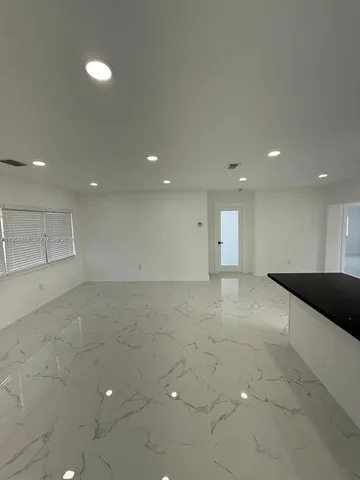 a kitchen with stainless steel appliances a refrigerator a sink a stove a microwave and island