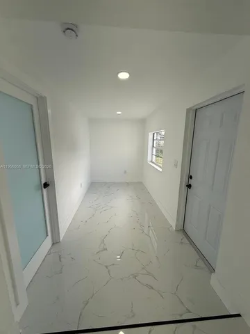 a kitchen with granite countertop sink and cabinets