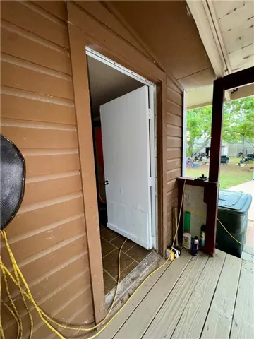 a view of a room with wooden floor and windows