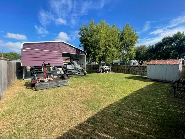 a view of a swimming pool with lawn chairs under an umbrella