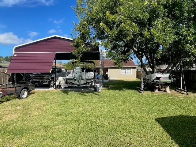 a view of a house with backyard porch and sitting area