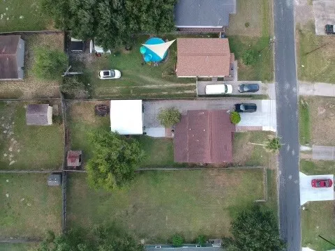 an aerial view of a house with a yard