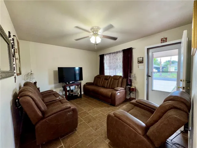 a living room with furniture and a flat screen tv
