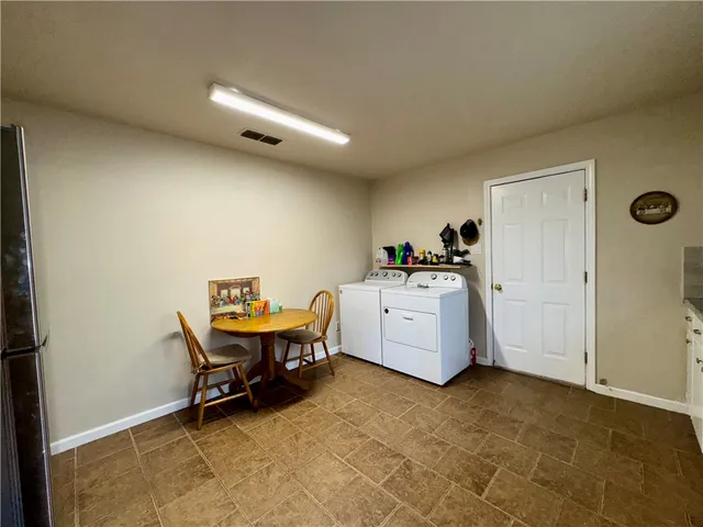 a utility room with furniture and window