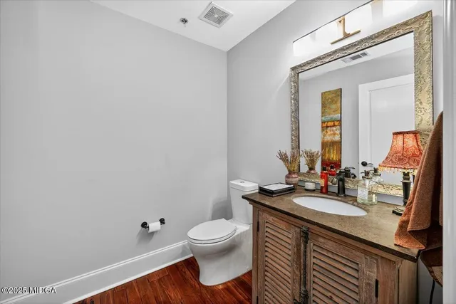 a bathroom with a sink a toilet and mirror