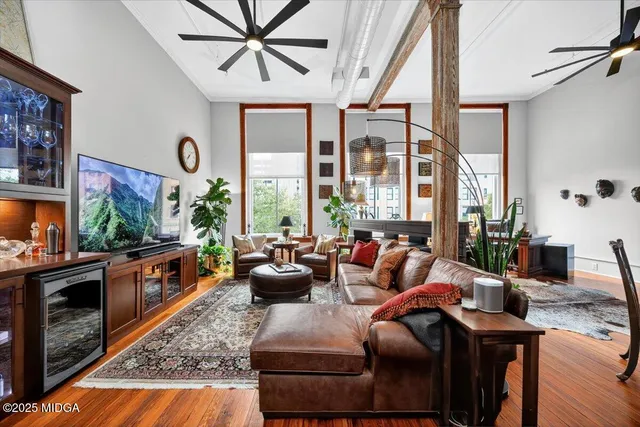 a living room with furniture fireplace and flat screen tv