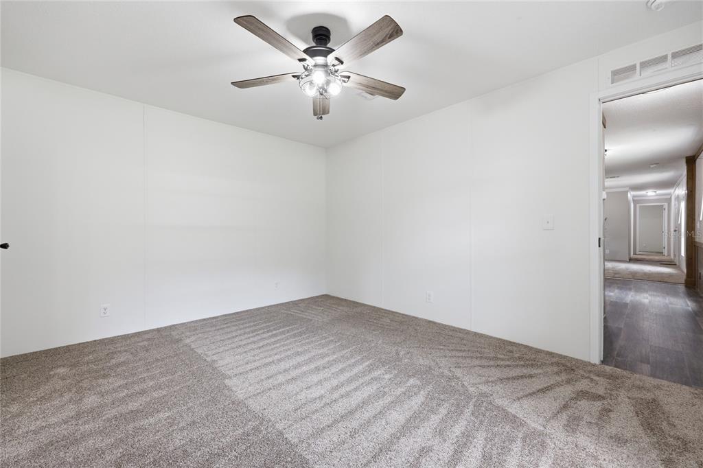 215 Southwest Alpine Place High Springs, FL 32643 - Photo 25 of 41 a view of an empty room with a chandelier fan
