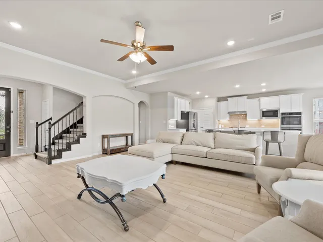 a living room with furniture and kitchen view