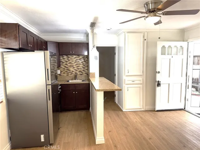 a kitchen with refrigerator and window