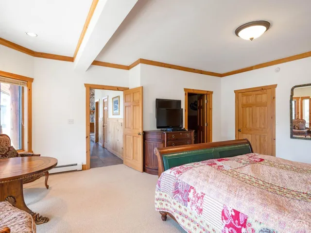 a bedroom with a bed and a large window