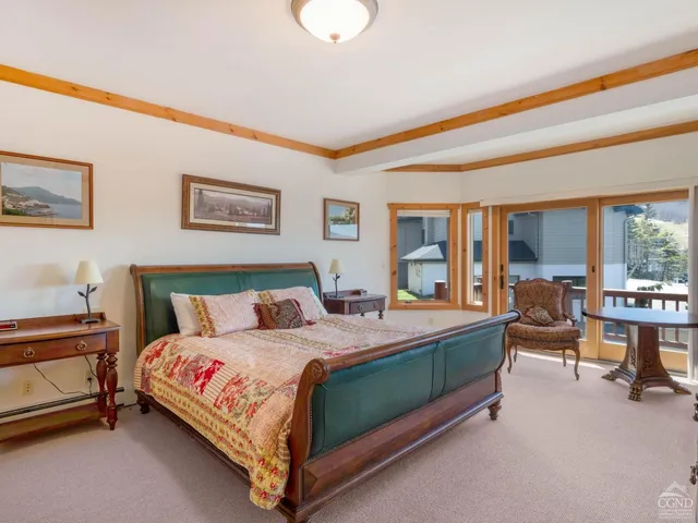 a spacious bedroom with a bed and a fireplace