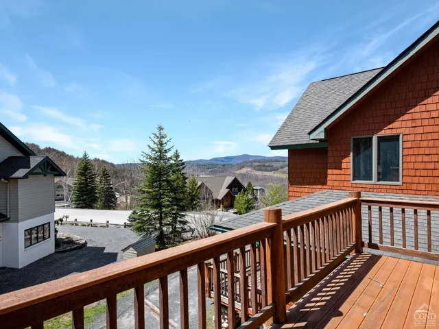 a spacious bedroom with a bed and a flat screen tv
