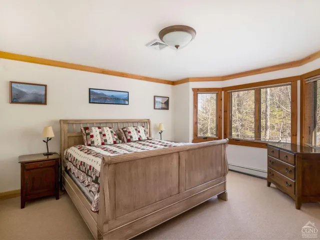 a bedroom with furniture and a flat screen tv
